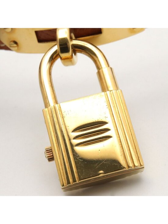 HERMÈS “Kelly” watch in gold-plated metal and brown leather  Hermes Watch Kelly Gold Leather